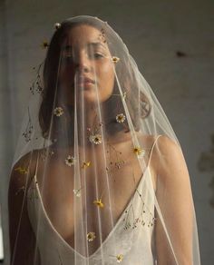 a woman wearing a veil with flowers on it