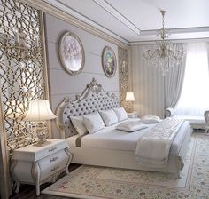 a large white bed sitting in a bedroom next to a chandelier and window