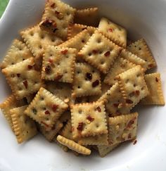 a white bowl filled with crackers on top of a table