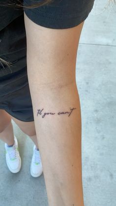 a woman with a tattoo on her arm that reads, you are my only friend