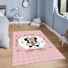 a bedroom with a minnie mouse rug on the floor