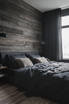 a large bed sitting next to a window in a bedroom