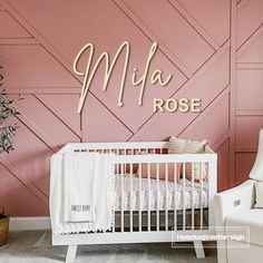 a baby's room with pink walls, white furniture and a wooden name sign