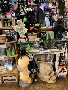 a room filled with lots of different types of halloween decorations and decorating items on top of wooden shelves