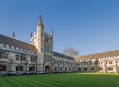 a large building with a clock tower on the top of it's front lawn