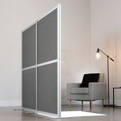 a living room with a chair and a partition