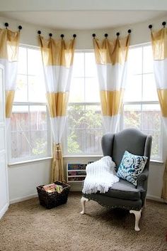 a gray chair sitting in front of a window