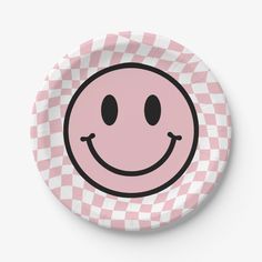 a pink and white checkered plate with a smiley face on the front, in black outline