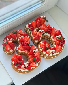 there are many cookies decorated with strawberries on the top one is shaped like a number