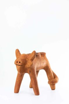 a small wooden toy dog on a white background