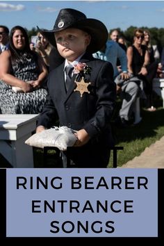 This is a pinterest pin. The title is ring bearer entrance songs. The photo is of a ring bearer wearing a cowboy hat. Ring Barrer, Ring Bearer Ideas, Ring Bearer Security, Flower Girl And Ring Bearer, Songs Images, Bear Songs, Entrance Songs, Best Ring, Song Images