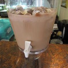 a glass filled with ice cream sitting on top of a counter