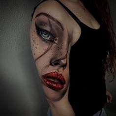 a woman's face painted with makeup and red lipstick, as if it were an art work