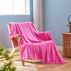 a chair with a pink blanket on it