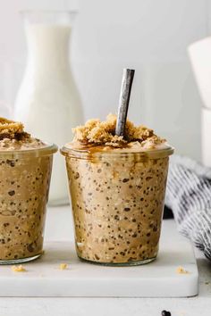 two cups filled with oatmeal sitting on top of a counter