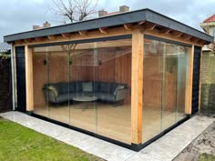 a couch sitting in the middle of a room with glass walls on top of it