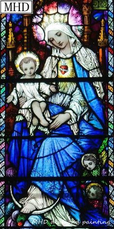 a stained glass window with a woman holding a child