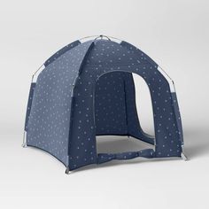 a blue tent with white polka dots on the front and sides, open to show it's interior