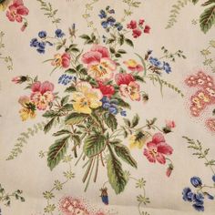 an image of a flowered fabric with many colors and flowers on it's surface