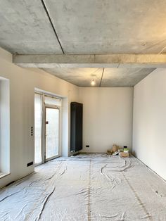 an empty room that is being renovated with white paint on the walls and flooring