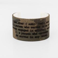 Make a sentimental statement with the word "Soldier" defined and engraved into camo leather over a silver 1.5-inch. Brass Cuff, Soldier, Camo, Silver Plated