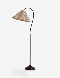 a lamp that is sitting on top of a table with a light shade over it