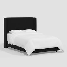 an image of a bed with white sheets and blue headboard on the bottom half