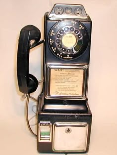 an old fashioned phone is hanging on the wall