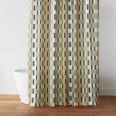 a shower curtain with an orange and grey checkered pattern