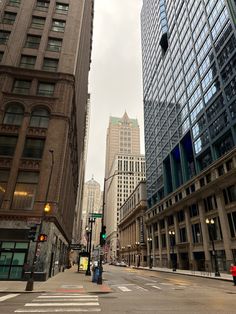 an empty city street with tall buildings in the background