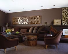 a living room filled with lots of furniture and decor on top of carpeted flooring