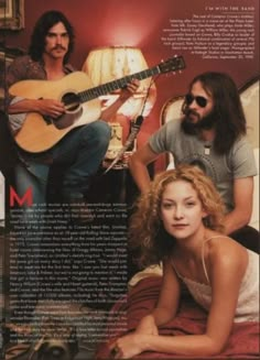 a woman laying on top of a bed next to a man with a guitar in his hand