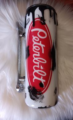 a coca - cola can is sitting on a furry surface