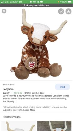 a stuffed animal with long horns sitting on top of it's back legs and head