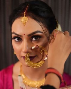 a woman with an elaborate nose ring and gold jewelry