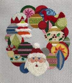 a close up of a cross stitch pattern with santa claus and other christmas items on it