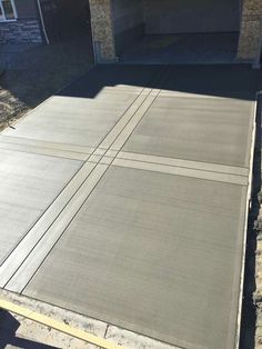 an empty parking lot in front of a house that is being built into the ground