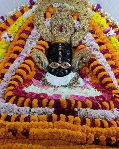 the statue is decorated with flowers and garlands