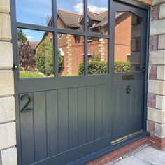 an image of a house through the glass door window with brick wall and red brick building in the background