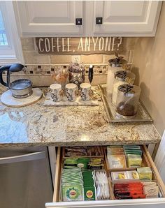 an open drawer in a kitchen filled with coffee