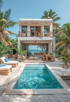 an outdoor swimming pool surrounded by palm trees and lounge chairs with the ocean in the background