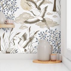 the wallpaper in this kitchen is designed to look like it has cranes and trees on it