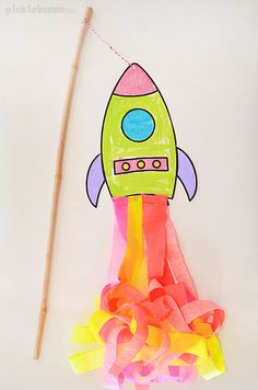 a paper rocket with streamers and a stick