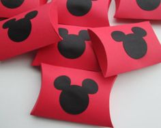 several pieces of red paper with black mickey mouse heads on them