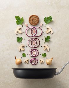 an image of food being cooked in a frying pan with mushrooms and onions on the side