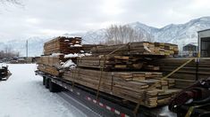 the truck is loaded with lumber and ready to be unloaded in the wintertime