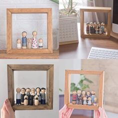 a person holding a wooden frame with small figurines in it and two pictures on the wall