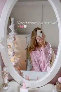 a woman taking a selfie in front of a mirror with the words merry christmas to everyone