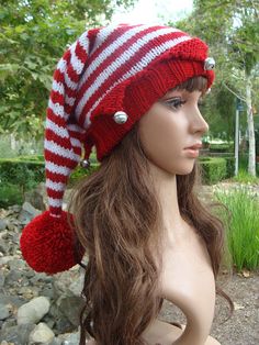 a mannequin head wearing a red and white knitted hat