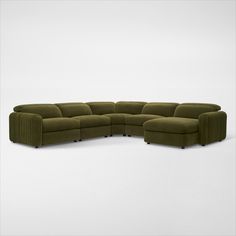 a large green sectional couch on a white background with no one in it or someone else